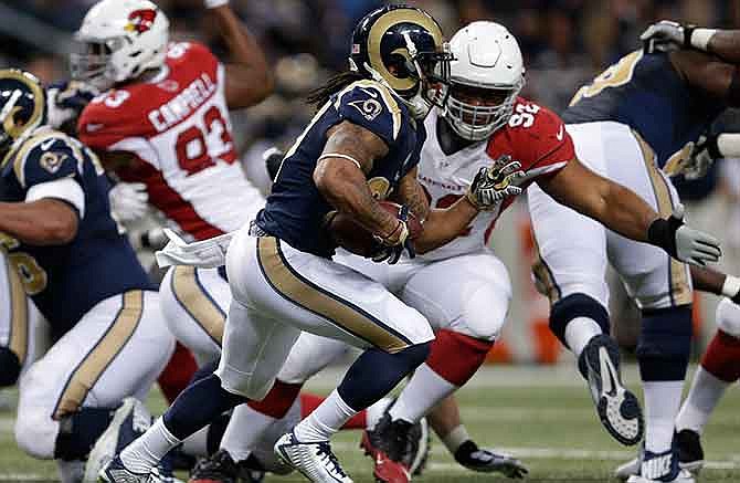St. Louis Rams running back Tre Mason (27) runs during the first half of an NFL football game against the Arizona Cardinals Thursday, Dec. 11, 2014 in St. Louis. 