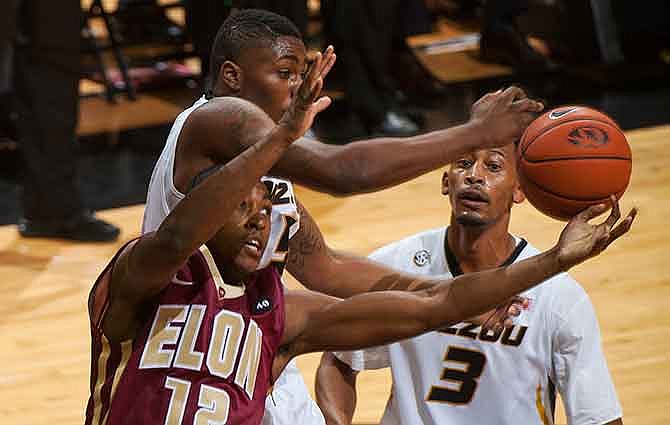 Elon's Christian Hairston, left, battles Missouri's D'Angelo Allen, top left, for a rebound in front of Johnathan Williams III during the first half of an NCAA college basketball game Thursday, Dec. 11, 2014, in Columbia, Mo. 