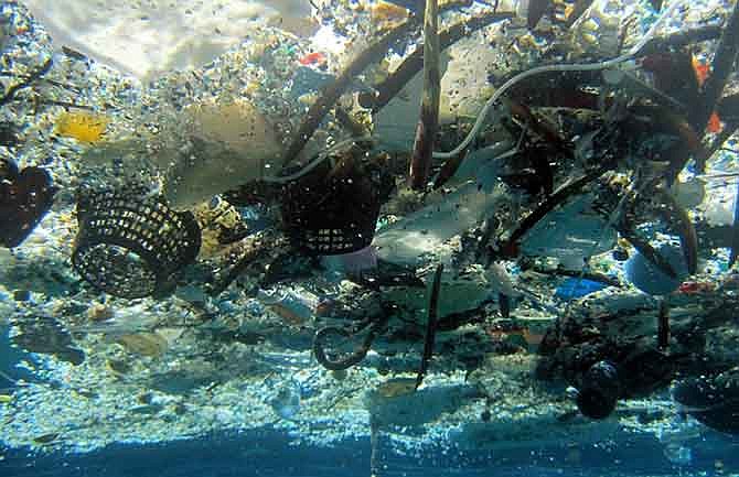 This file 2008 photo provided by NOAA Pacific Islands Fisheries Science Center shows debris in Hanauma Bay, Hawaii. A new study estimates nearly 270,000 tons of plastic is floating in the world's oceans. That's enough to fill more than 38,500 garbage trucks if each truck carries 7 tons of plastic. The figure appears in a study published, Wednesday, Dec. 10, 2014, in the scientific journal PLOS ONE. Researchers say the plastic is broken up into more than 5 trillion pieces. 