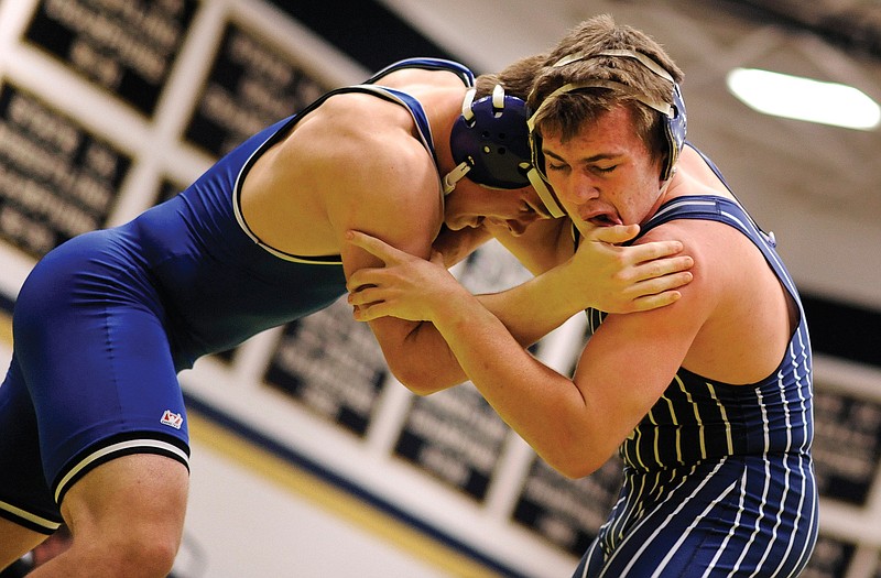 Helias' Nick Feely battles Grain Valley's Parker McBride in the 182-pound match in the second round of Friday's Missouri Duals at Helias.