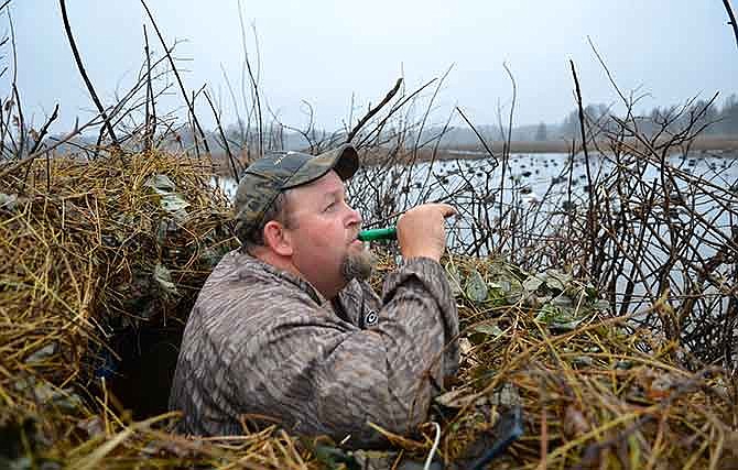 Billy Blakely of Blue Bank Resort calls ducks into his hole on Reelfoot Lake.
