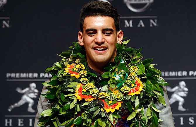 Oregon quarterback Marcus Mariota speaks during a news conference after being awarded the Heisman Trophy, Saturday, Dec. 13, 2014, in New York.