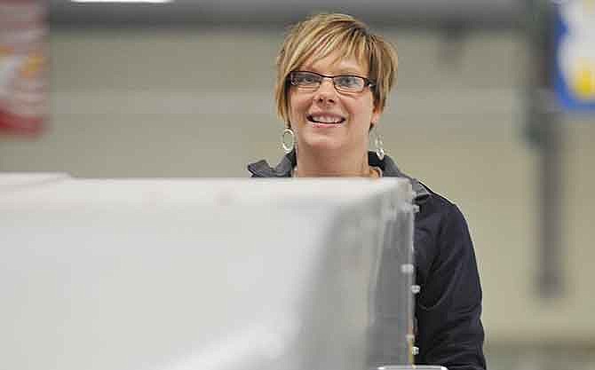 Kerri Washington operates the ice surfacing machine at Jefferson City's Washington Park Ice Arena.