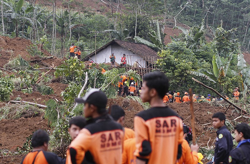 Rescuers search for the victims of a landslide that swept away a village in Jemblung, Central Java, Indonesia. Rescuers pulled more bodies from the debris Sunday after heavy rain in central Indonesia loosened soil and collapsed a hill, setting off the landslide that left dozens of people dead or missing.
