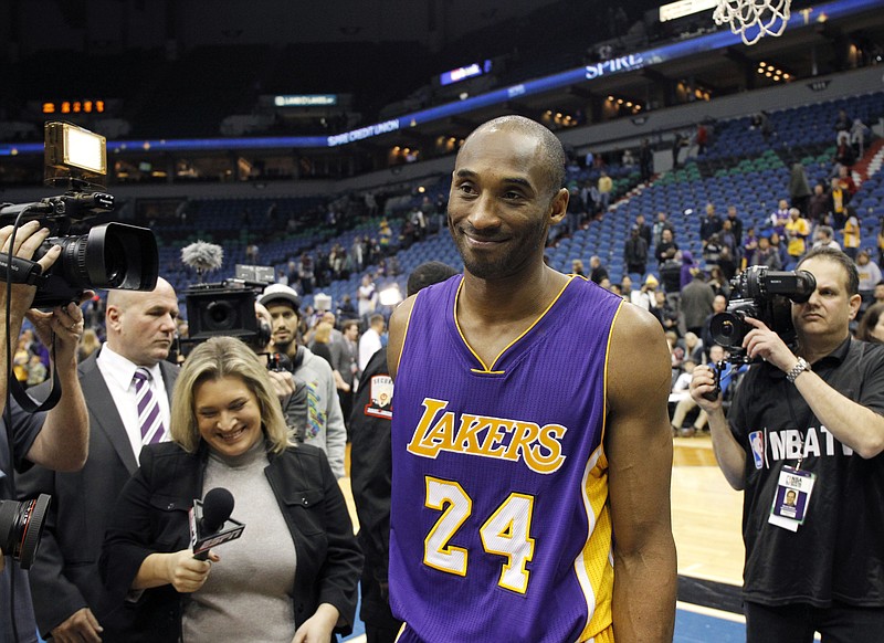 Lakers guard Kobe Bryant smiles as he leaves the court after Sunday night's win against the Timberwolves in Minneapolis.