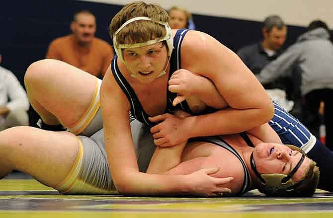 Lane Rose of Helias works Oakville's Joey Walters onto his back as he closes in on a win by fall in their 285-pound matchup Saturday in the Missouri Duals in Rackers Fieldhouse.