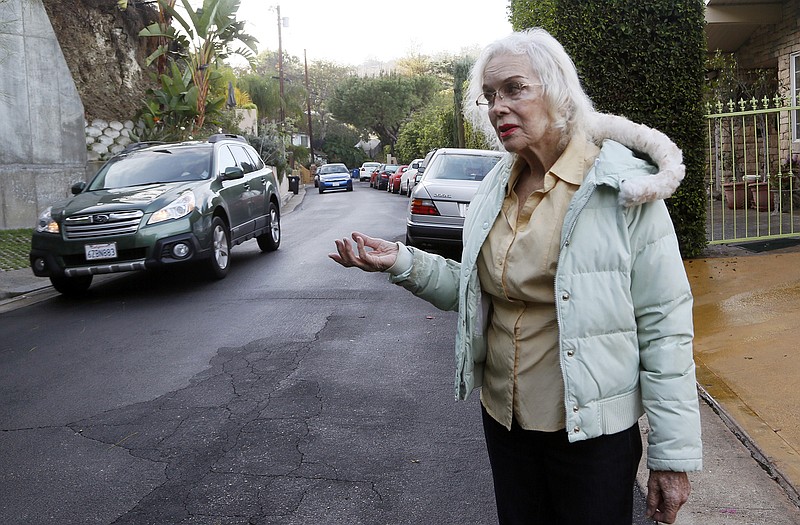 Paula Hamilton stands on a street outside her house in the Sherman Oaks section of Los Angeles. "The traffic is unbearable now. You can't even walk your dog," said Hamilton, who lives on a once quiet little street. When the people whose houses hug the narrow warren of streets paralleling the busiest urban freeway in America began to see bumper-to-bumper traffic rushing by their homes a year or so ago they were baffled. When word spread that the explosively popular new smartphone app Waze was sending many of those cars through their neighborhood in a quest to shave five minutes off a daily rush-hour commute, they were angry and ready to fight back. 