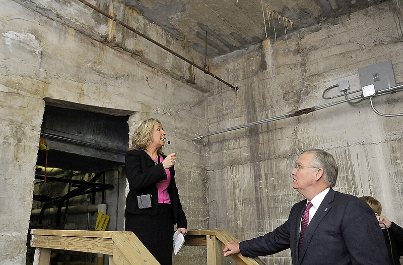 Gov. Jay Nixon, right, and a handful of Missouri legislators listen to Cathy Brown, director of Facilities Management, at left, as she leads a tour through the dirt and, in areas, mud floors that make up the sub-basement of the Capitol's foundation.