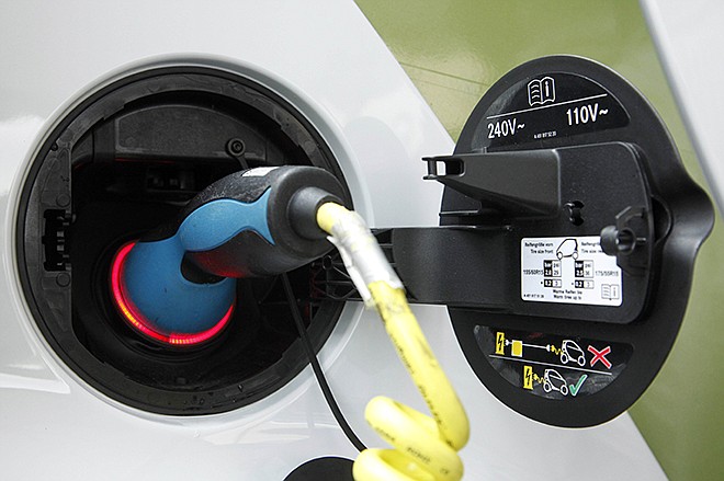 An electric plug charges a Smart Car electric drive vehicle in New York. People buying all-electric cars where coal supplies the power may think they are helping the environment. But a new study shows those coal-powered plug-in vehicles can be making the air dirtier and worsening global warming.