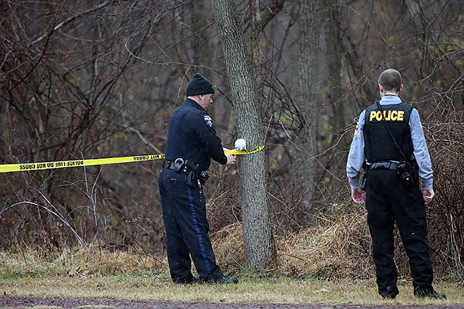 Police cordon off a wooded area during the search for suspect Bradley William Stone, Tuesday, in Pennsburg, Pennsylvania. Schools closed and hospitals and other public places tightened security Tuesday as police in suburban Philadelphia hunted for the Marine veteran suspected of killing his ex-wife and five of her relatives.