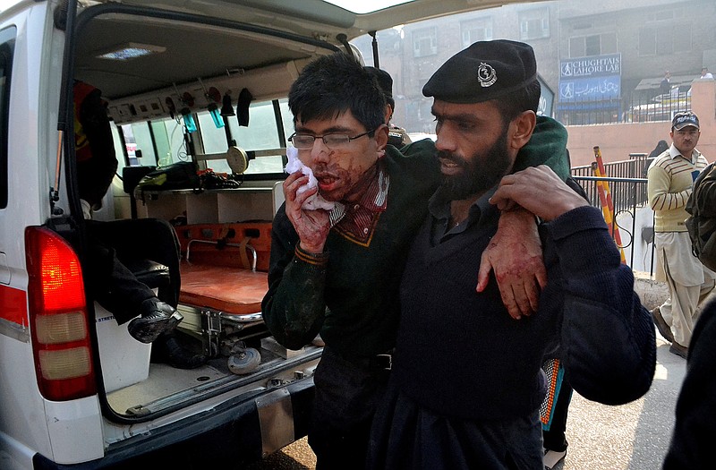 
A Pakistani soldier helps a wounded student to an ambulance after the youth survived a Taliban attack on his school in Peshawar. The attack claimed 141 lives, most of them students.