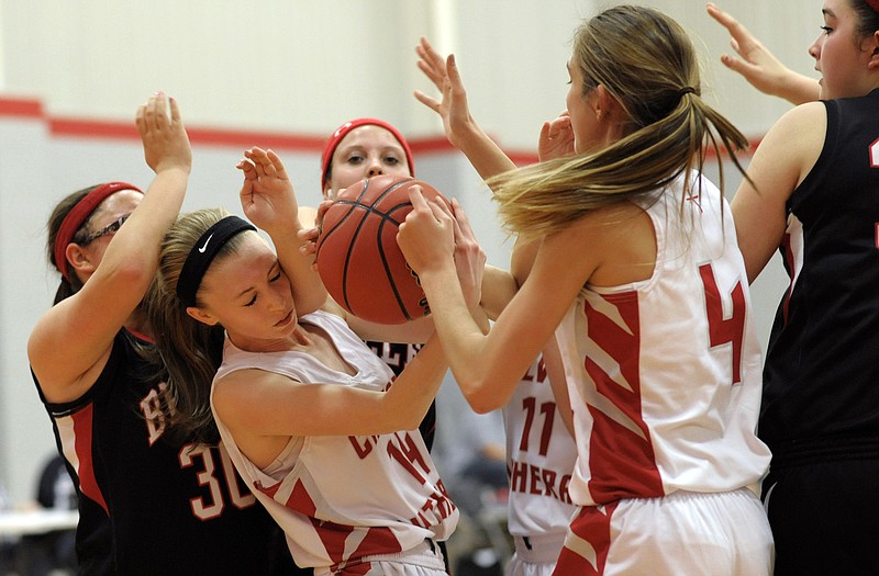 Calvary Lutheran's Maci Steen (14) comes down with a rebound in front of Belle's Emily Koch during Monday night's game at Calvary Lutheran.
