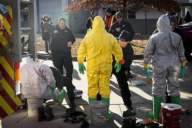 Local EMTs receive help tightening their masks and taping off airways in their hazmat suits Wednesday during an exercise designed to practice responding to a patient with a highly contagious disease. In the wake of the recent Ebola crisis, local response agencies ran a drill Wednesday morning at JCFD Station 3 on Industrial Drive. The drill consisted of an initial call, the prepping of the hazmat team, transport and hospitalization of the patient.