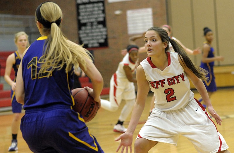 Jefferson City guard McKenzie Gourley collapses on Hickman's Kelsey Mirts as the Lady Jays go into a press during the second half of Wednesday night's game at Fleming Fieldhouse.