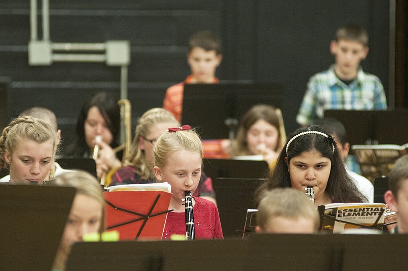 Young musicians in Fulton Middle School's Sixth Grade Hornet Band perform at the middle school during its Winter Fine Arts Night on Wednesday. The sixth graders played Christmas classics "Jingle Bells," "Up On the Housetop," "Jolly Old St. Nick," and "Ode to Joy" for a gymnasium full of their loved ones.