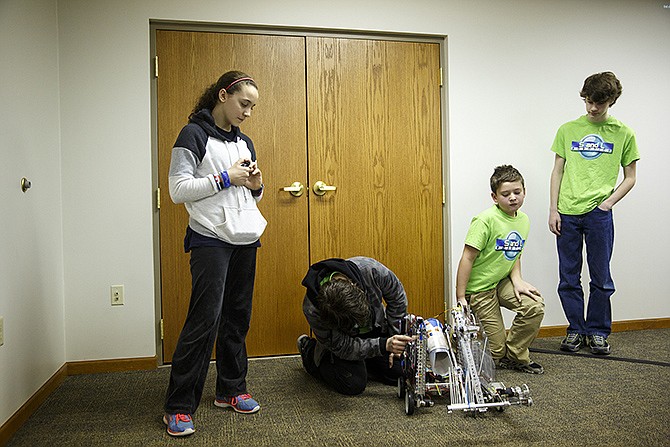 Cole County 4-H robotics group, S&L Robotics, demonstrates the operation of one of their award-winning robots Thursday afternoon at the Cole County MU Extension Office during a visit from MU Chancellor R. Bowen Loftin and Vice Provost of MU Extension Michael Ouart. 