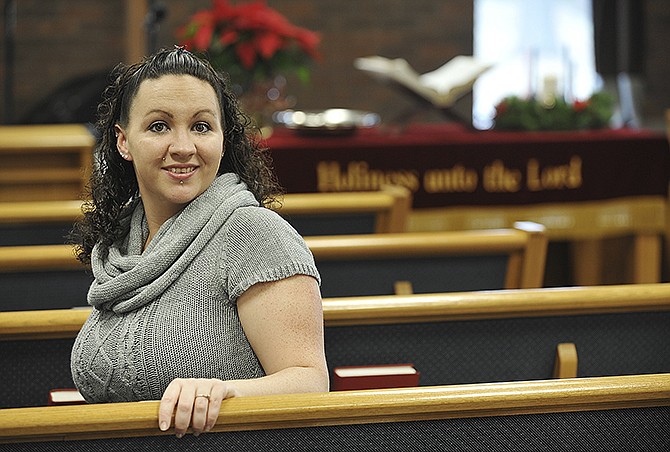 Marissa Quiroz poses in the Salvation Army chapel, where she regularly attends services and her baby, Yasmin, was dedicated. 