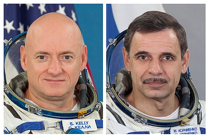 This photo combo shows NASA astronaut Scott Kelly and Russian cosmonaut Mikhail Kornienko. Kelly and Kornienko will rocket into orbit from Kazakhstan in March, 2015. They will spend a year aboard the International Space Station. At a news conference Thursday at UNESCO headquarters in Paris, Kelly and Kornienko said they anticipate many scientific gains from their mission. 