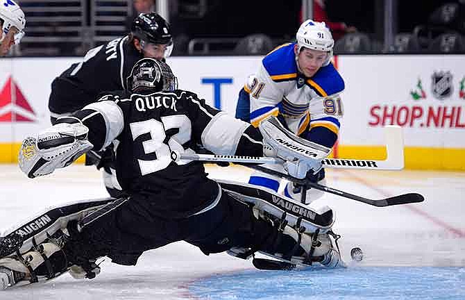 St. Louis Blues right wing Vladimir Tarasenko, right, of Russia, tries to get a shot in against Los Angeles Kings goalie Jonathan Quick during the first period of an NHL hockey game, Thursday, Dec. 18, 2014, in Los Angeles. 