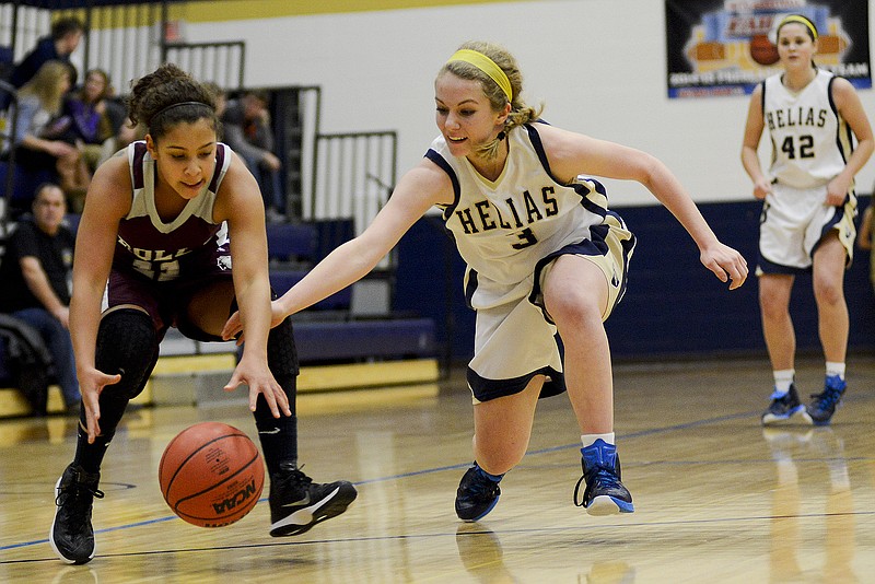 Helias' Clarissa Fennessey and Rolla's Amber Walters fight for a loose ball during the first half of Friday's gam eat Rackers Fieldhouse.