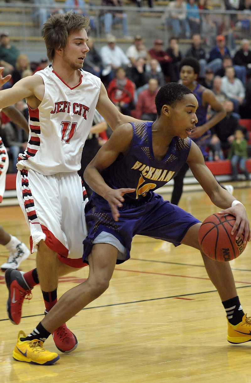 Isaac Roling of the Jays guards Hickman's Grant Beasley during Thursday night's game at Fleming Fieldhouse.