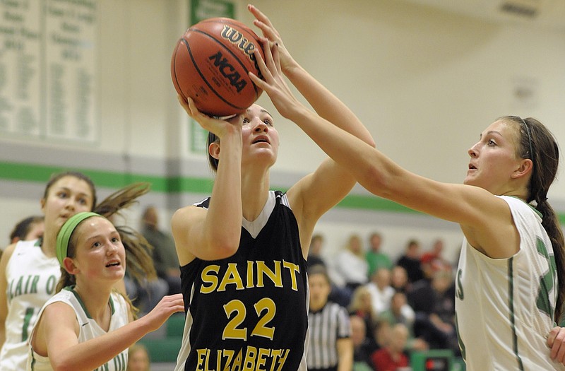 St. Elizabeth's Megan Kemna has her shot partially blocked by Blair Oaks' Macyn Wilbers in the second half of Thursday night's game in Wardsville.