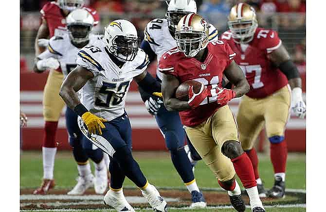 San Francisco 49ers running back Frank Gore (21) runs past San Diego Chargers inside linebacker Kavell Conner (53) during the first quarter of an NFL football game in Santa Clara, Calif., Saturday, Dec. 20, 2014. 