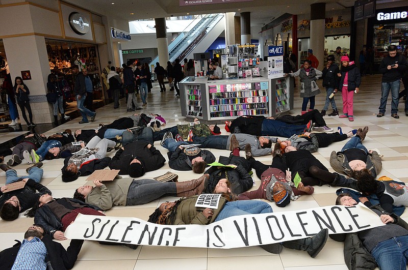 Protestors stage a "die-in" to chant "black lives matter" and protest the recent grand jury decisions from Ferguson, Mo. and Staten Island in New York City during a demonstration at Crossgates Mall in Guilderland, N.Y. on Saturday, Dec. 20, 2014 - one of the busiest holiday shopping days of the year.