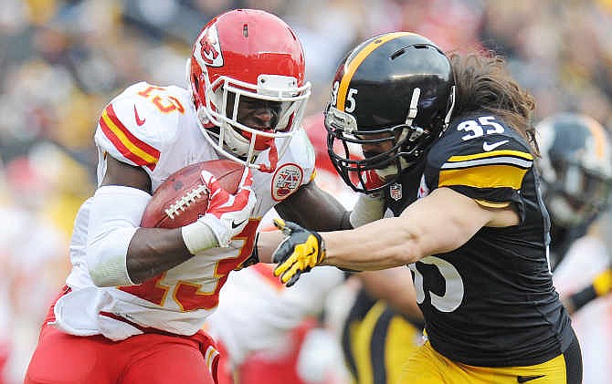 Kansas City Chiefs running back De'Anthony Thomas (13) is tackled by Pittsburgh Steelers defensive back Ross Ventrone (35) during the first half of an NFL football game in Pittsburgh, Sunday, Dec. 21, 2014.