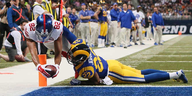 New York Giants wide receiver Rueben Randle (82) dives into the endzone to score on a seven-yard touchdown reception against St. Louis Rams cornerback Trumaine Johnson (22) in third quarter action during the NFL football game on Sunday, Dec. 21, 2014, at the Edward Jones Dome in St. Louis.