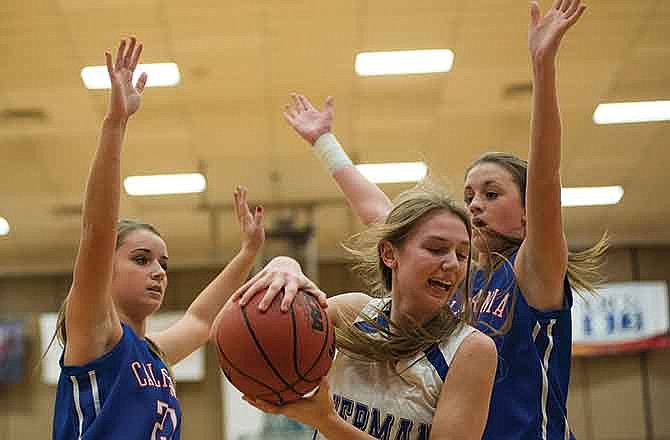 California's Renee Roberts (left) and Katie Imhoff defend Hermann's Cameron Hackman in the key Saturday in the Missouri National Guard Shootout at Fleming Fieldhouse.