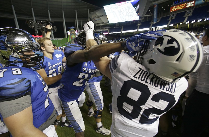 Players scuffle on the field Monday after Memphis defeated Brigham Young 55-48 in double overtime during the inaugural Miami Beach Bowl.
