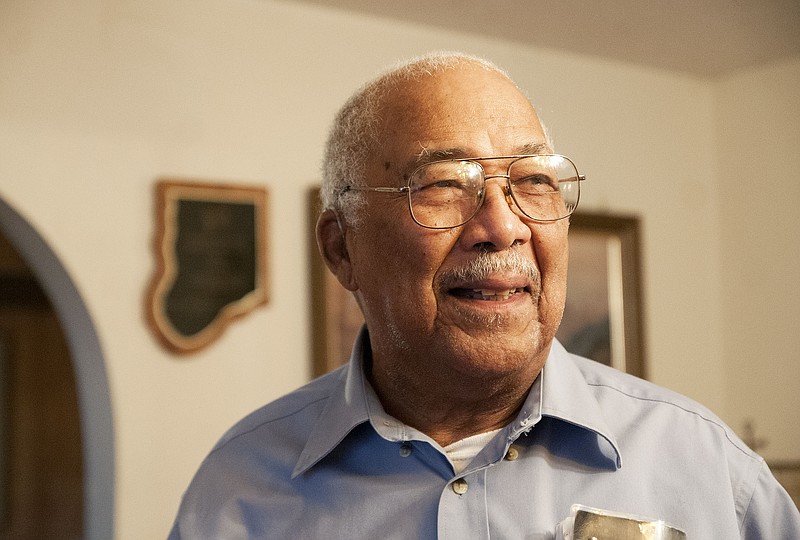 Jack McBride, World War II veteran, smiles while talking to a reporter inside his Fulton home.