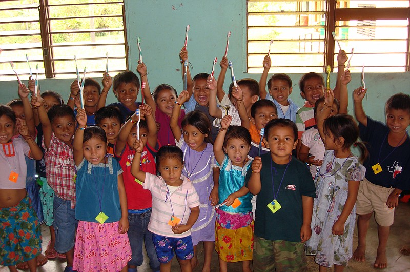 Some of the village children receive new toothbrushes that were brought by the dentists during a Medical Missions for Christ, International mission trip.