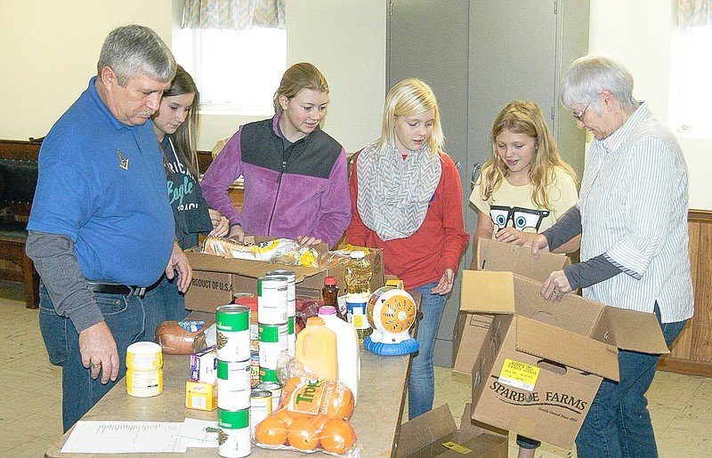 Democrat photo / David A. Wilson

Among the volunteers packaging food baskets for the California Masonic Lodge #183 A.F. & A.M. are, from left, Stuart Inglish, Reagan Liebi, Hannah Hill, Lauren Hill, Lacey Lucus and Pam Liebi. The basket were presented to needy families in the area.