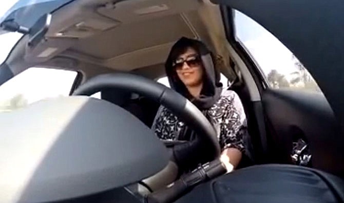 This Nov. 30, 2014 image made from video released by Loujain al-Hathloul, shows her driving towards the United Arab Emirates - Saudi Arabia border before her arrest on Dec. 1, 2014, in Saudi Arabia. Two Saudi women, including al-Hathloul, detained for nearly a month after violating the kingdom's female driving ban have been referred Thuesday, Dec. 25, 2014 to a court established to try terrorism cases on charges related to comments they made on social media.