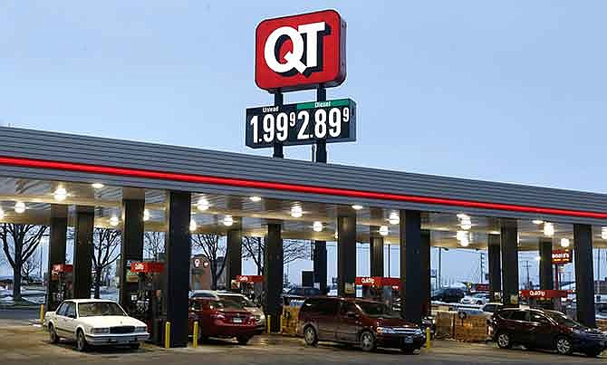 In this Friday, Dec. 19, 2014 file photo, motorists fill their tanks at a convenience store in Platte City, Mo., where prices dropped below $2-per-gallon for regular gas. 