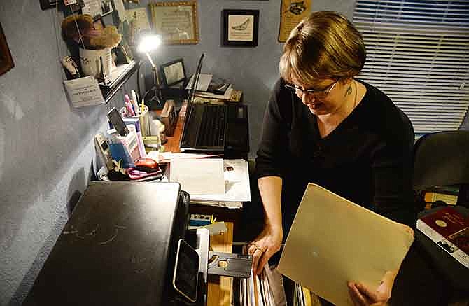 Laura Forbis files some paperwork from her home office. A professional organizer and owner of Managed Chaos, LLC, Forbis recommends organizing bills and paperwork to help get your home, and life, organized for the new year. 