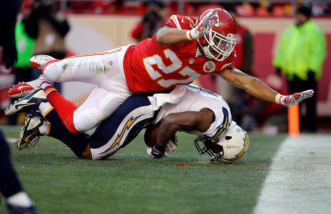 San Diego Chargers wide receiver Eddie Royal (11) can't control a touchdown pass against the defense of Kansas City Chiefs defensive back Kurt Coleman (27) during the second half of an NFL football game in Kansas City, Mo., Sunday, Dec. 28, 2014.