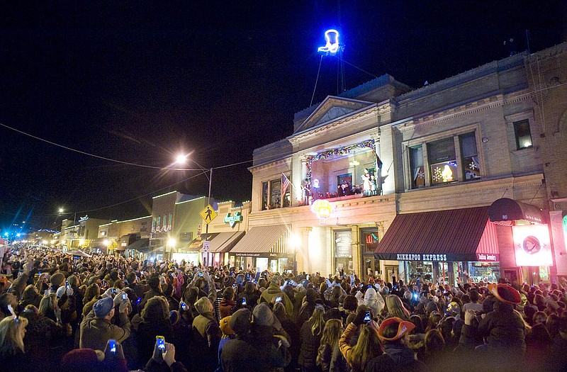 The crowd cheers last Dec. 31 as a lighted cowboy boot drops to the roof of the Palace Saloon New Year's Eve on Whiskey Row in downtown Prescott, Ariz.