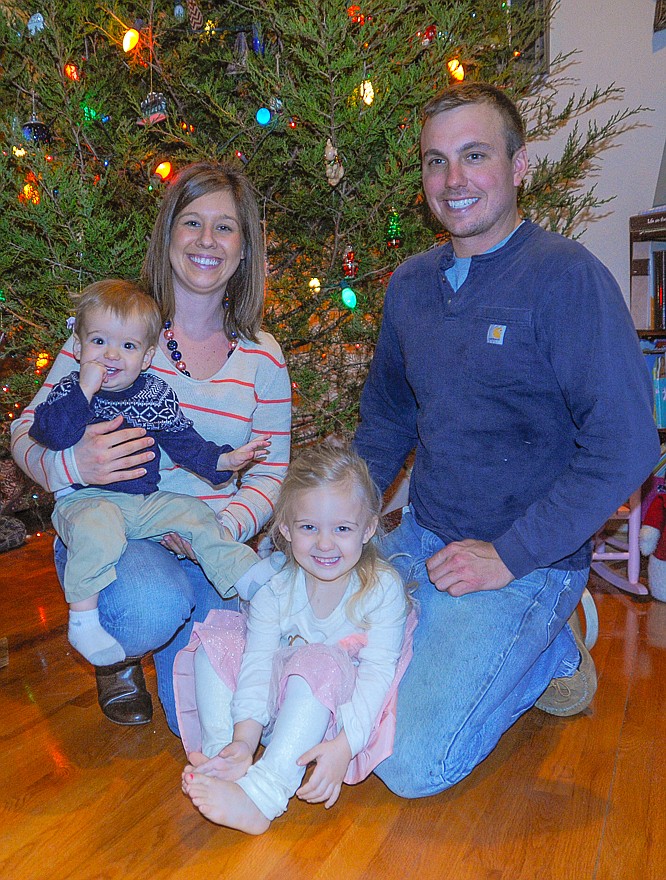 The Bieri family - Lee, 1; Holly; Lena, 3, and Eric - sat in front of their Christmas tree, which they cut down themselves, continuing a family tradition since Holly and Eric married seven years ago. Born Jan. 6, 2014, Lee was the winner of the 2014 First Baby of Moniteau County Contest.