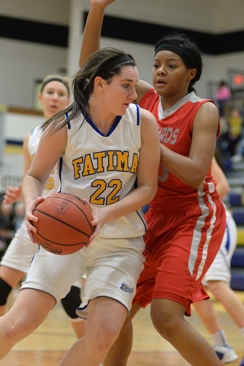 Kristen Boeckmann of Fatima looks to pass the ball during Monday's 71-54 win against Alton (Ill.) in the fifth-place game of the State Farm Holiday Hoops Invitational at Rackers Fieldhouse.
