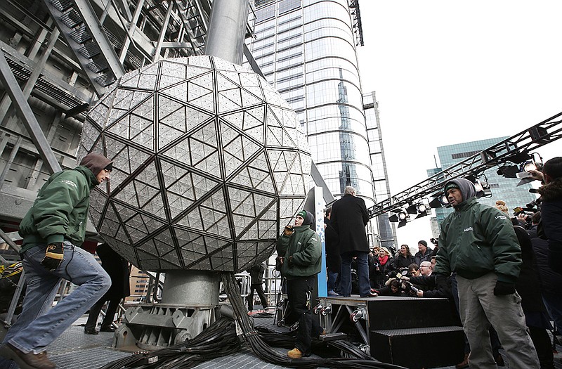 Workers prepare to test the Waterford crystal ball for the New Year's Eve celebration atop One Times Square in New York. The ball, which is 12 feet in diameter and weighs 11,875 pounds, is decorated with 2,688 Waterford crystals and illuminated by 32,256 LED lights. 