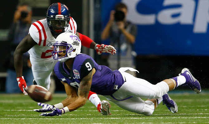 TCU wide receiver Josh Doctson (9) makes a catch against Mississippi defensive back Senquez Golson (21) during the first half of the Peach Bowl NCAA football game, Wednesday, Dec. 31, 2014, in Atlanta.