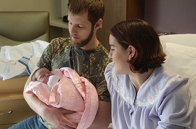 Jordan Wagoner holds his new daughter, Jennifer Rose, as mom Heather looks on at St. Mary's Hospital.
