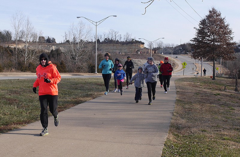 Runners make their way along the Greenway during the Ring in the New Year Mile.
