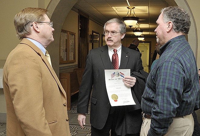 Sam Bushman, middle, visits with John Riley, left, and Ron Fitzwater after Bushman was sworn in as Cole County presiding commissioner Wednesday. Riley is court administrator and Fitzwater is chairman of the Cole County Republican Central Committee.