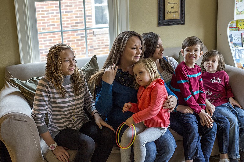 Amanda Miller, center, sits in her home with her five children, from left, Stephanie, 14, Addilyn, 4, Desiree, 16, Braden, 7, and Noah, 5. Recently Miller, along with neighbor Vickie Wieberg, decided to utilize the crowdfunding website gofundme.org to help her keep their family home while she studies to be a nurse.