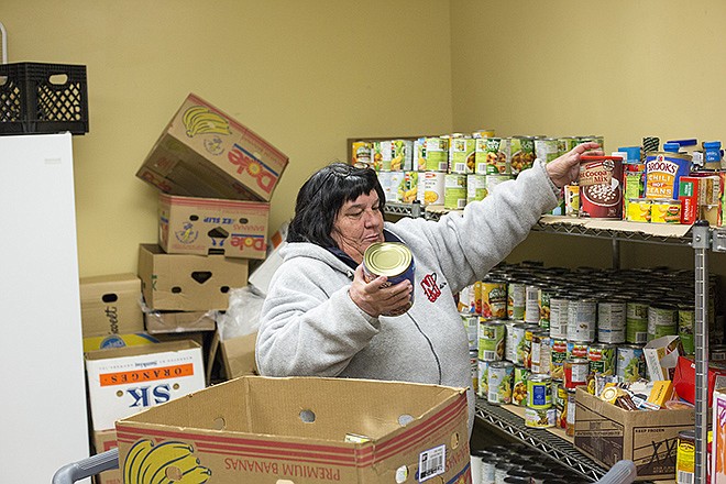 FILE: Salvation Army resident and volunteer Ruby Overman fills a box at the organization's food pantry headquarters.