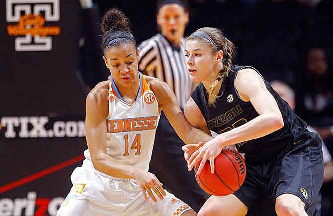 Tennessee guard Andraya Carter (14) attempts to steal the ball from Missouri guard Jordan Frericks (22) in the first half of an NCAA college basketball game Friday, Jan. 2, 2015, in Knoxville, Tenn. 